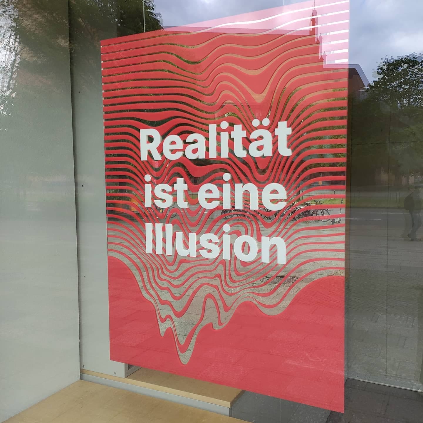 UV-printed mirrors floating in Illuseum Berlin shop windows โ motif appears to hover in space